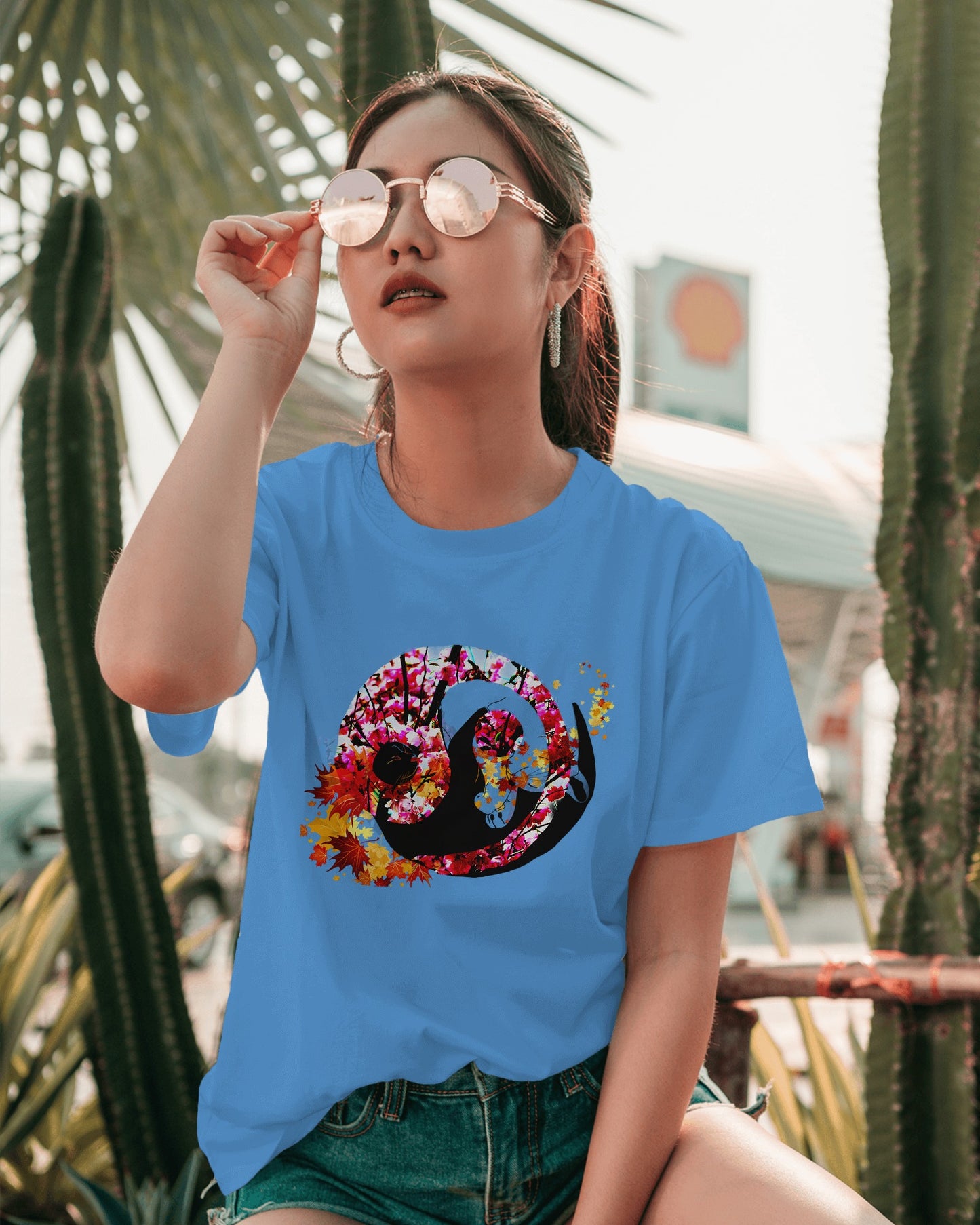 Soft Carolina Blue color t-shirt featuring artistic yin yang symbol created with black and white cats in circular balance