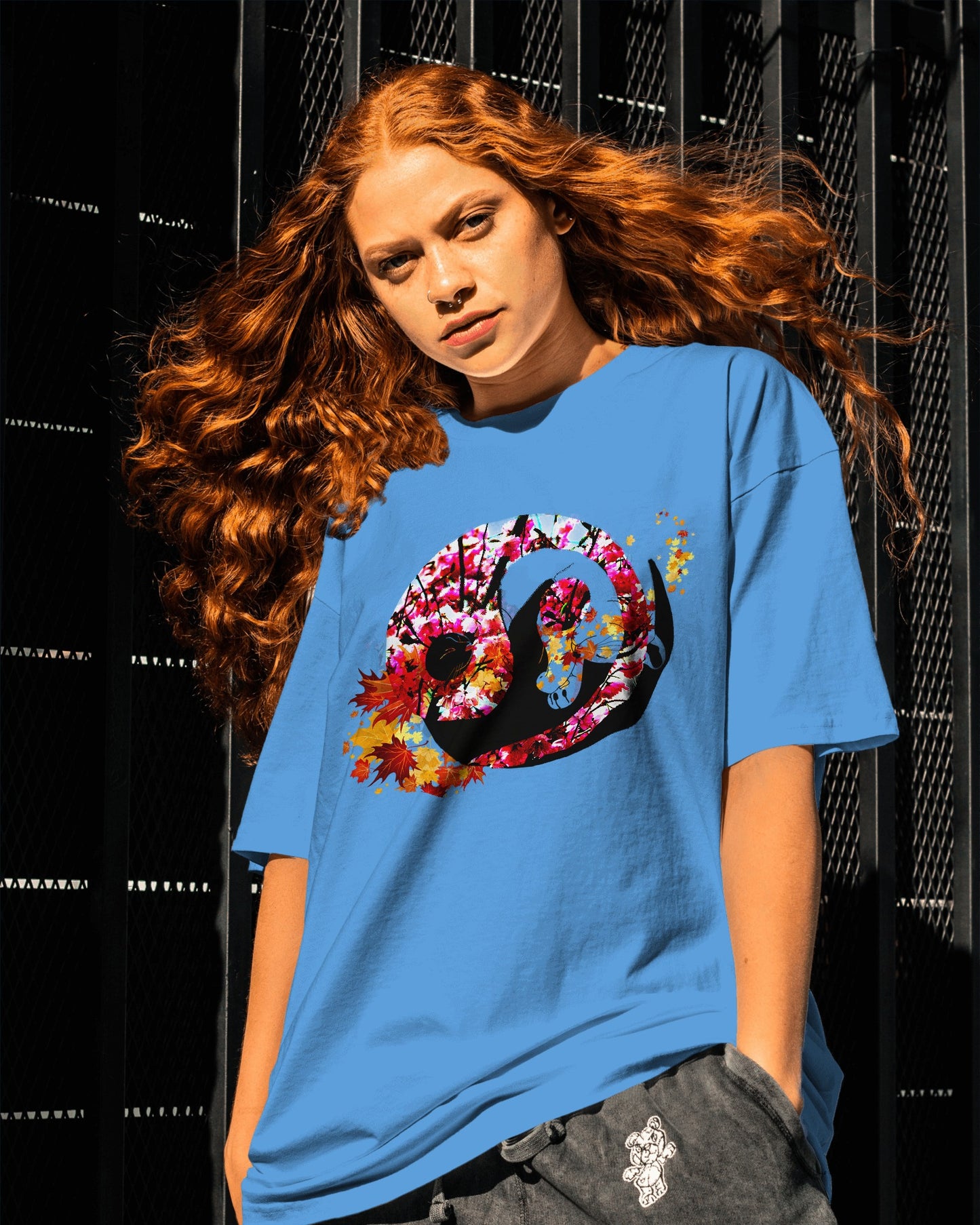 Soft Carolina Blue color t-shirt featuring artistic yin yang symbol created with black and white cats in circular balance