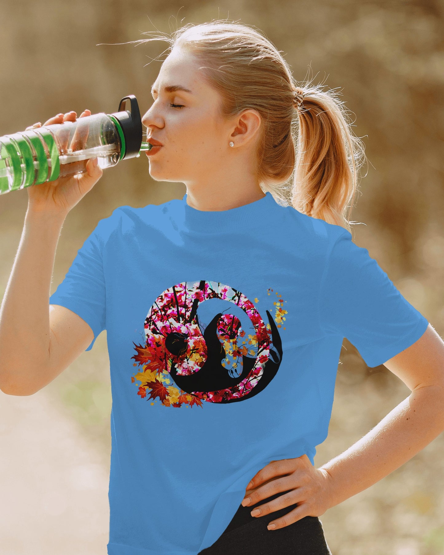 Soft Carolina Blue color t-shirt featuring artistic yin yang symbol created with black and white cats in circular balance